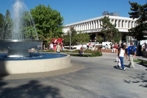 Photo of students walking by the fountain.