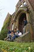 Students sitting on the steps of Centennial Hall.